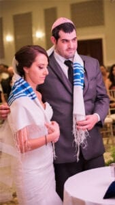Jewish Wedding couple with tallitot wrapping