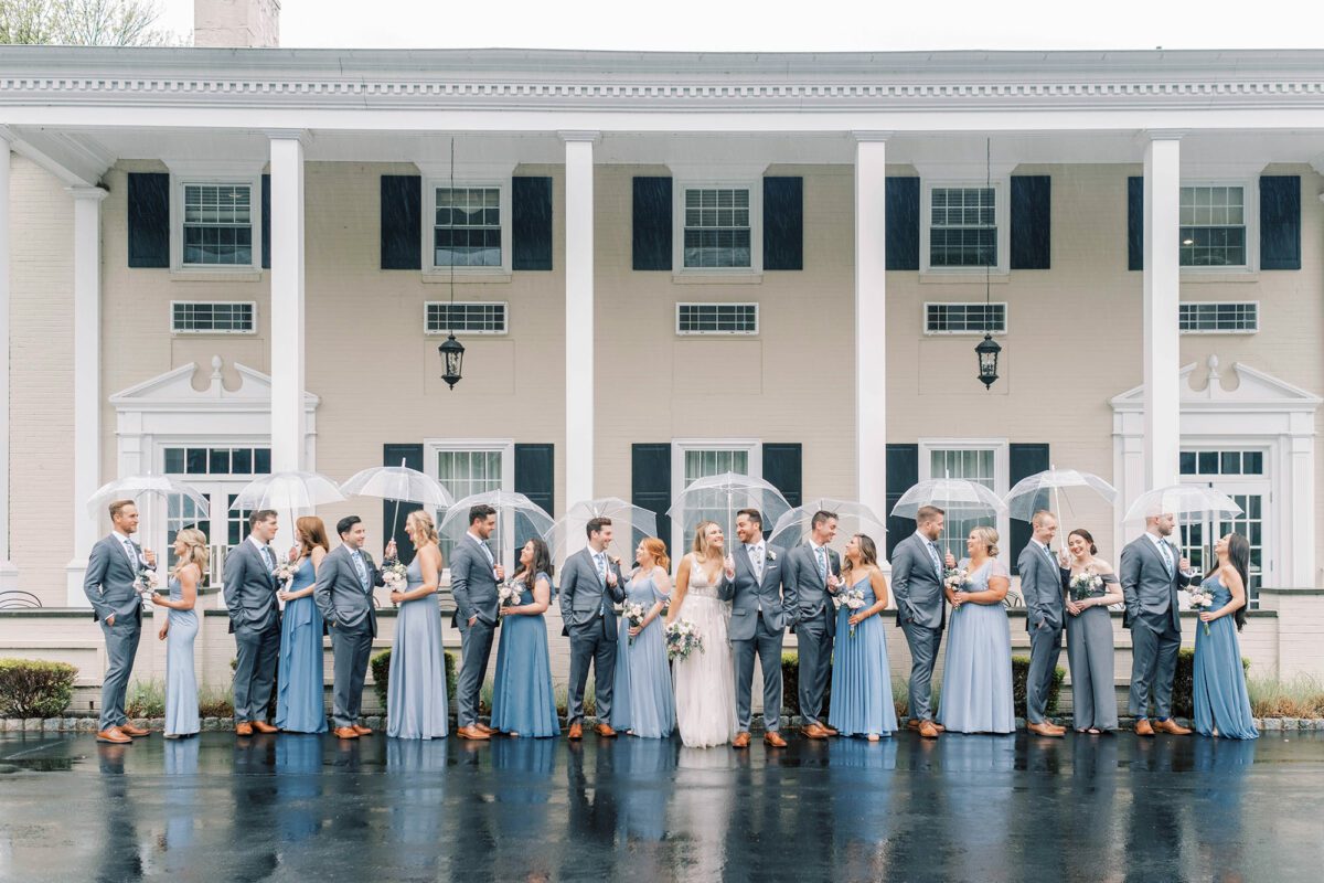 The Drexelbrook Mansion with Bridal Party Posing in the Rain