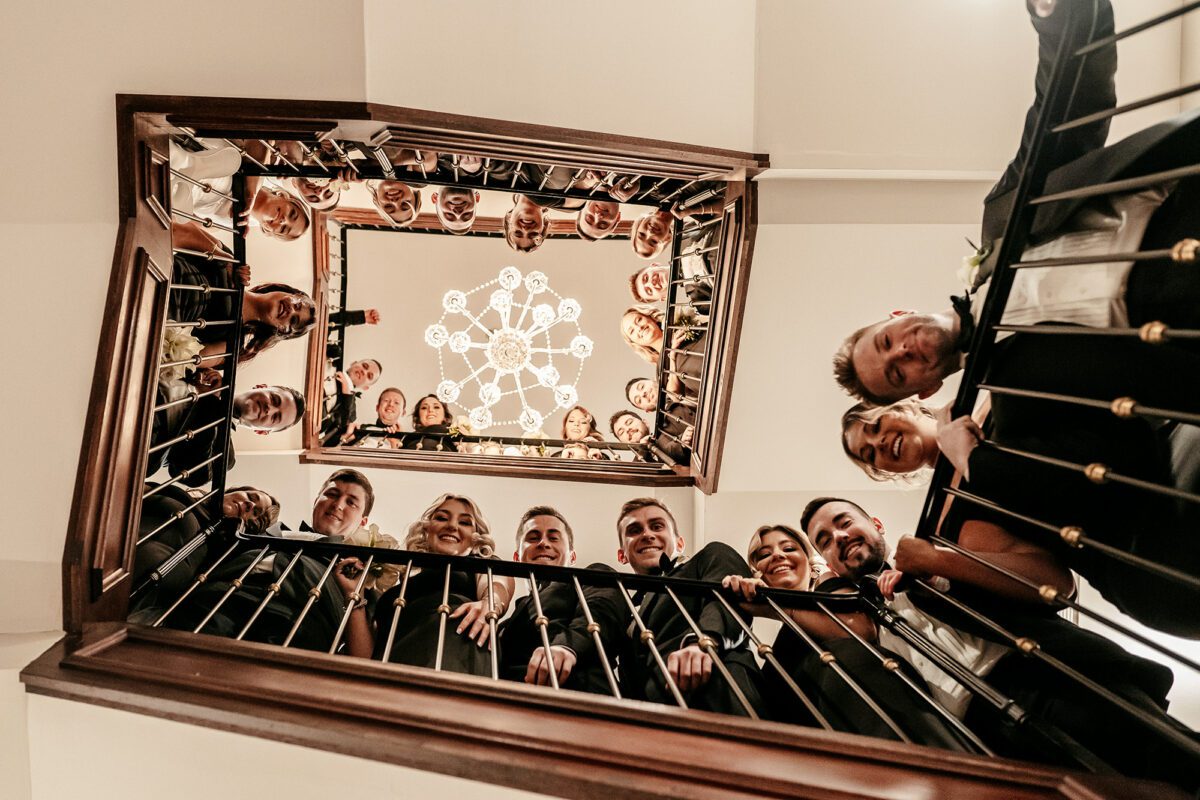 The Drexelbrook back stairwell filled with wedding bridal party photograph