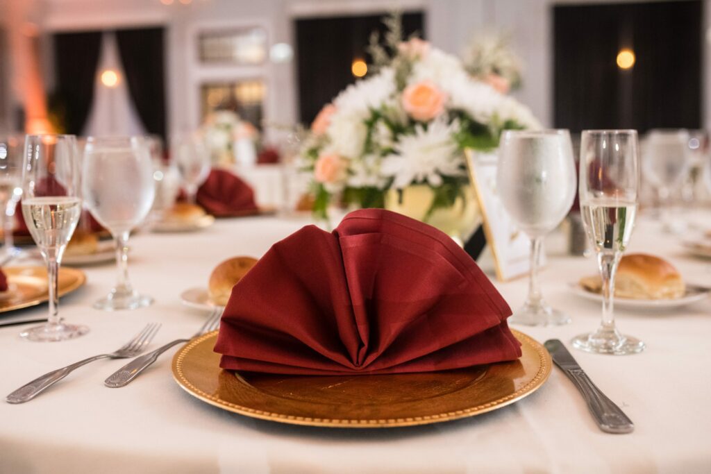 Burgandy and Gold napkin and plate table setting