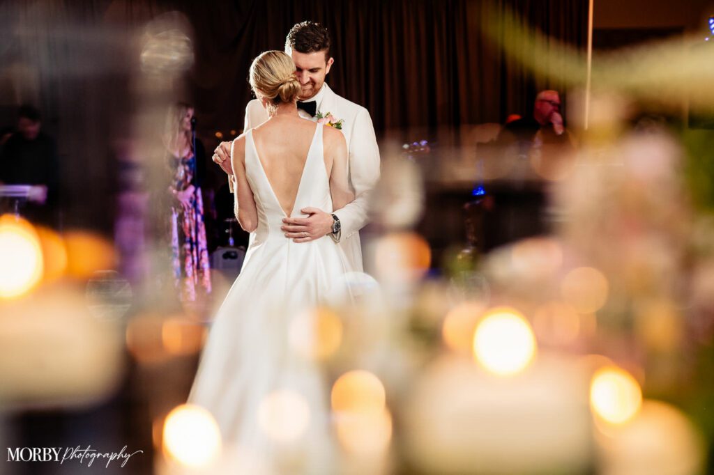 Close up image of a bride and groom dancing together during reception.
